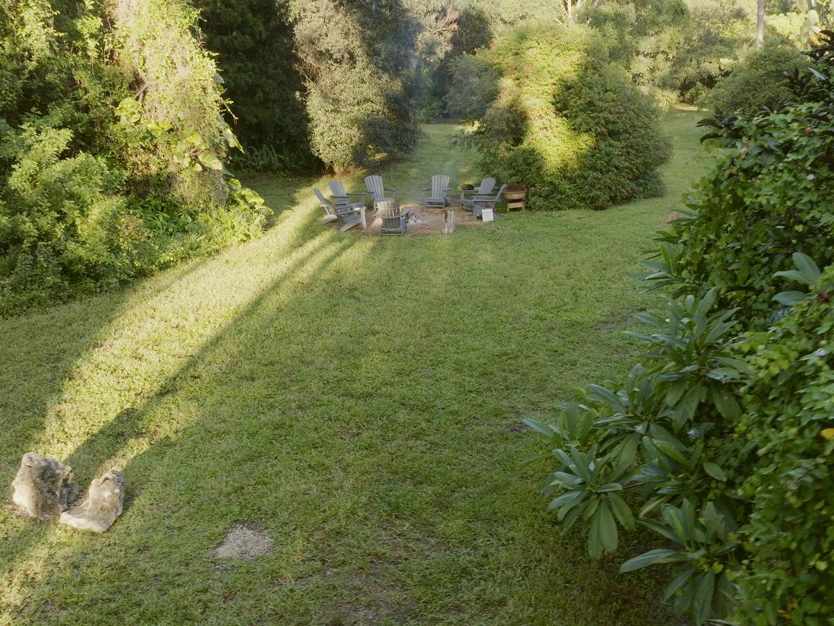 Morning light across the lawn to an empty circle of chairs